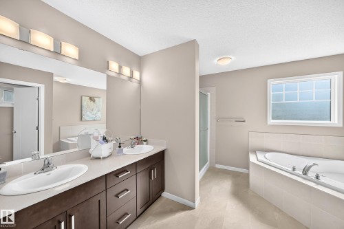 Dual vanity with undermount sinks and dark wood-finish cabinetry - 5147 Crabapple Link Sw, Edmonton, AB - Indoor Photo Showing Bathroom