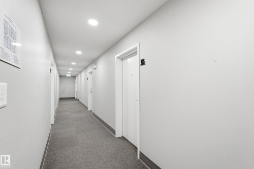 Recessed ceiling lighting, gray wall-to-wall carpeting, white doors, and light gray wall finishes - #106 856 Secord Bv Nw Nw, Edmonton, AB - Indoor Photo Showing Other Room