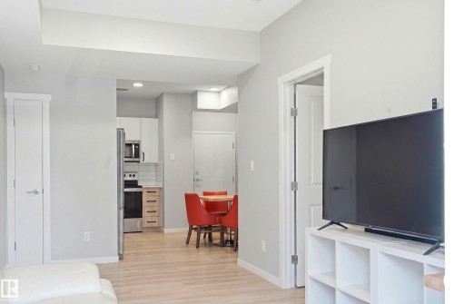 Light wood-finish flooring throughout - #106 856 Secord Bv Nw Nw, Edmonton, AB - Indoor Photo Showing Other Room
