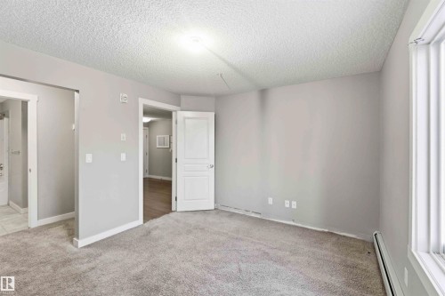 Carpeted room with light gray walls, white trim, and a window with horizontal blinds - #114 2207 44 Av Nw, Edmonton, AB - Indoor Photo Showing Other Room
