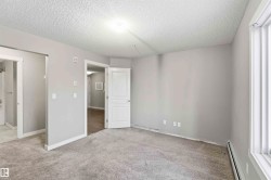 Carpeted room with light gray walls, white trim, and a window with horizontal blinds - 