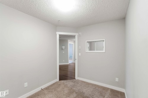 Carpeted room featuring light gray walls and white trim - #114 2207 44 Av Nw, Edmonton, AB - Indoor Photo Showing Other Room