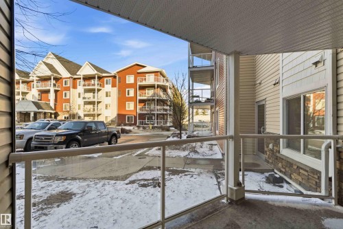 Patio featuring a glass railing system and a textured concrete floor - #114 2207 44 Av Nw, Edmonton, AB - Outdoor
