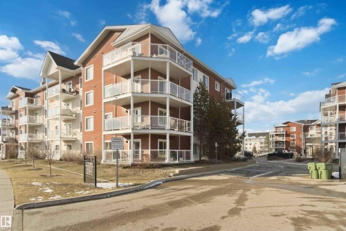 Multi-story residential building featuring red brick and light-colored siding - #114 2207 44 Av Nw, Edmonton, AB - Outdoor With Facade