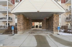 Building exterior featuring a stone-clad entrance with a covered portico - 
