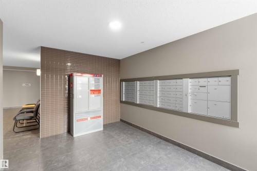 Mailroom featuring multiple individual mailboxes and a parcel locker system - #114 2207 44 Av Nw, Edmonton, AB - Indoor Photo Showing Other Room