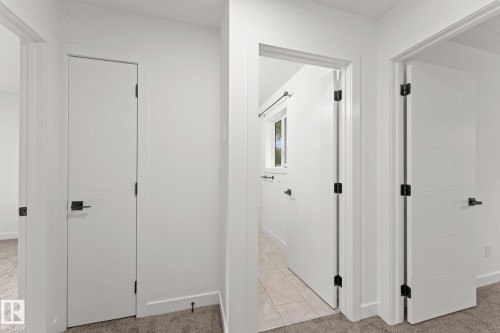 White interior doors with horizontal paneling, matte black hardware, and crisp white trim - 10825 93 Street Nw, Edmonton, AB - Indoor Photo Showing Other Room