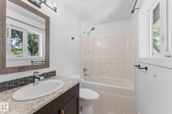 Vanity with a surface-mount sink, chrome faucet, and textured backsplash - 