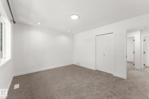 Window with black rod hardware, recessed lighting, flush-mount ceiling fixture, and carpeted flooring - 10825 93 Street Nw, Edmonton, AB - Indoor Photo Showing Other Room