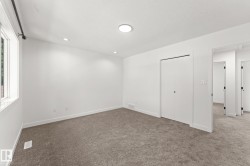 Window with black rod hardware, recessed lighting, flush-mount ceiling fixture, and carpeted flooring - 
