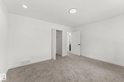 Neutral tone interior with recessed lighting and a flush mount fixture - 