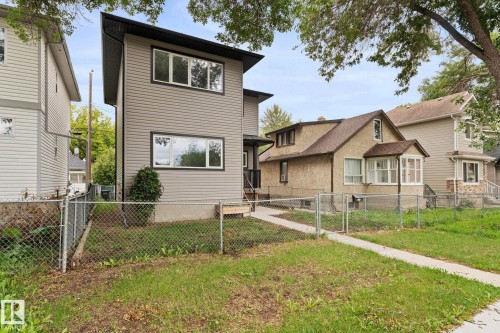 Two-story exterior with light gray horizontal siding, black trim accents, and a dark-colored roofline - 10825 93 Street Nw, Edmonton, AB - Outdoor