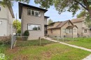 Two-story exterior with light gray horizontal siding, black trim accents, and a dark-colored roofline - 10825 93 Street Nw, Edmonton, AB  - Outdoor 