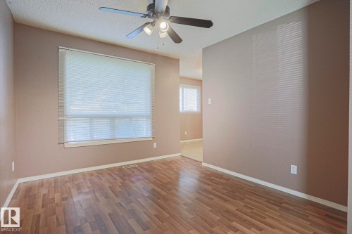 Wood-finish flooring with a neutral wall palette - #45 1651 46 St Nw, Edmonton, AB - Indoor Photo Showing Other Room