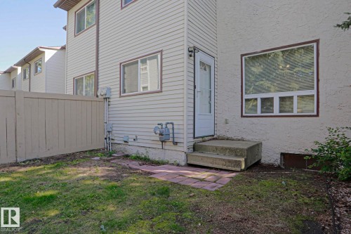Exterior featuring vinyl siding, stucco finish, and a privacy fence - #45 1651 46 St Nw, Edmonton, AB - Outdoor With Exterior