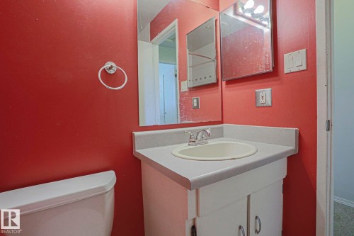 Bathroom featuring a single vanity with an integrated sink, chrome faucet, and mirrored medicine cabinet - #45 1651 46 St Nw, Edmonton, AB - Indoor Photo Showing Bathroom