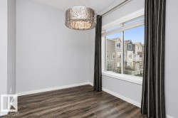 Wood-finish flooring, white trim, and light gray walls - 