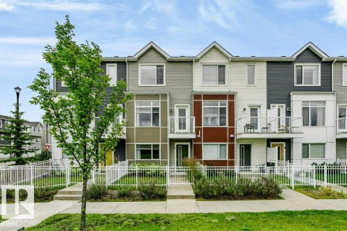 Contemporary townhome exterior featuring multi-toned siding, white trim, and a prominent balcony - #6 215 Saddleback Rd Nw, Edmonton, AB - Outdoor With Facade