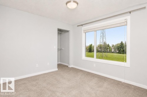Neutral tone painted walls - #6 215 Saddleback Rd Nw, Edmonton, AB - Indoor Photo Showing Other Room