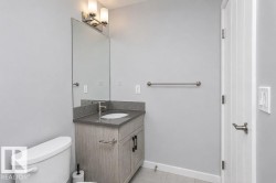 Vanity with a countertop, integrated sink, and modern hardware - 