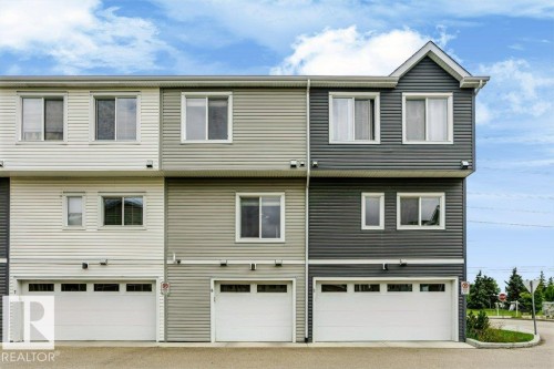 Multi-level townhouse exterior featuring horizontal siding in varied neutral tones - #6 215 Saddleback Rd Nw, Edmonton, AB - Outdoor