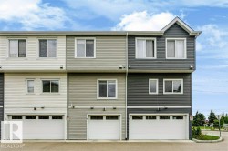 Multi-level townhouse exterior featuring horizontal siding in varied neutral tones - 