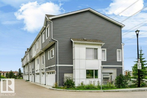 Two-story townhome with grey horizontal siding and white trim - #6 215 Saddleback Rd Nw, Edmonton, AB - Outdoor