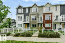 Modern townhome exterior featuring multi-toned siding, distinct gables, private balconies, and individual front entrances - 