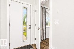 White entry door with a vertical glass insert - 