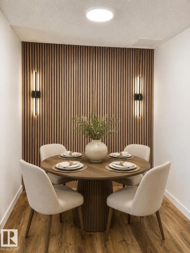 Wood-finish flooring with a slatted wood accent wall - 224 Callingwood Two Two Nw, Edmonton, AB - Indoor Photo Showing Dining Room