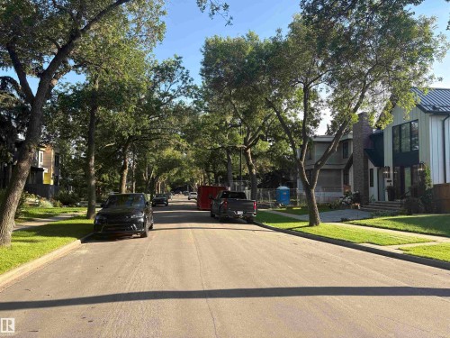 Lush tree-lined street with mature foliage, well-maintained sidewalks, and manicured lawns - 10845 140 Street Nw, Edmonton, AB - Outdoor