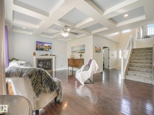 Coffered ceilings, gas fireplace, hardwood flooring, large windows and Open Concept making entertaining easy!! - 30 Shorewood Crescent, Leduc, AB - Indoor With Fireplace