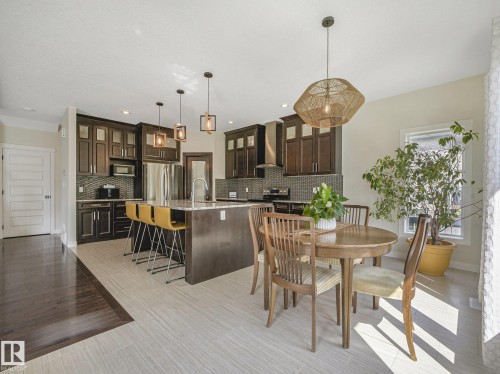 Massive island, Granite counter tops, maple cupboards and ceramic tile flooring - 30 Shorewood Crescent, Leduc, AB - Indoor Photo Showing Dining Room