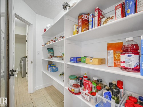 H-U-G-E walk thru pantry directly off of the double attached garage - 30 Shorewood Crescent, Leduc, AB - Indoor With Storage