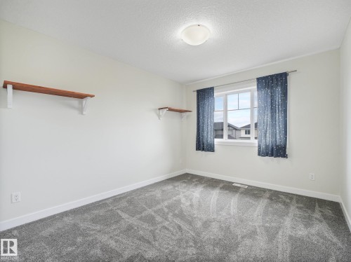 Bedroom #3, new carpets, fresh paint - 30 Shorewood Crescent, Leduc, AB - Indoor Photo Showing Other Room