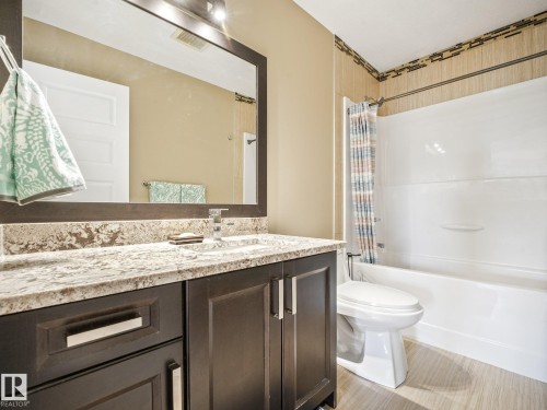 4 piece bath upstairs, granite counter tops, ceramic tile flooring, new light fixture - 30 Shorewood Crescent, Leduc, AB - Indoor Photo Showing Bathroom
