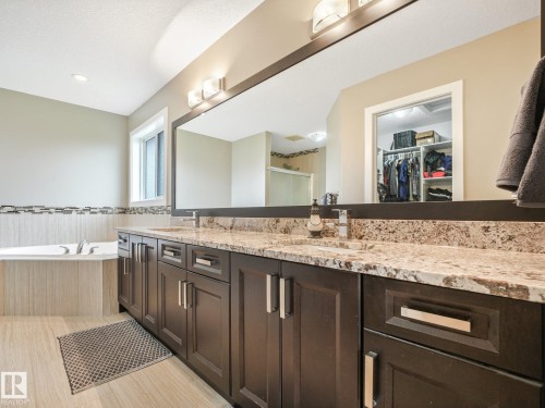 Massive counter space and storage. Granite counter tops with his and her sinks! - 30 Shorewood Crescent, Leduc, AB - Indoor Photo Showing Bathroom