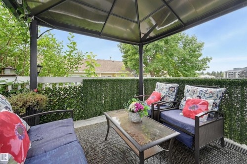 Covered outdoor patio area featuring a privacy screen - #8 1920 Millwoods Rd E Nw, Edmonton, AB - Outdoor With Deck Patio Veranda