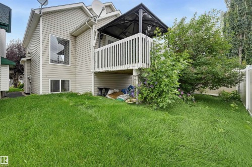 Rear exterior featuring siding, a second-story deck with a gazebo, and a lower-level window - #8 1920 Millwoods Rd E Nw, Edmonton, AB - Outdoor