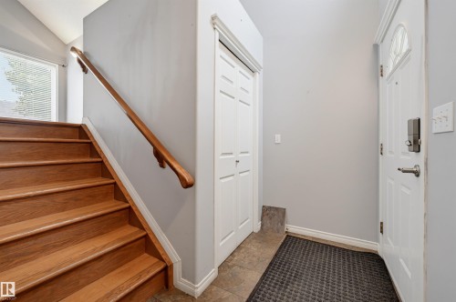 Hardwood stairs with a classic wooden handrail, leading to an upper level - #8 1920 Millwoods Rd E Nw, Edmonton, AB - Indoor Photo Showing Other Room