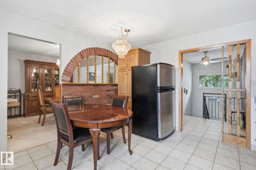 Tiled flooring, brick archway, recessed lighting, and wood-finish cabinetry - 7 Graham Avenue, St. Albert, AB - Indoor Photo Showing Dining Room