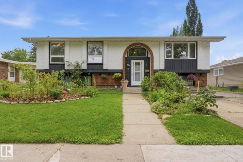 White and black exterior with an arched entryway, multiple windows, and a concrete pathway - 7 Graham Avenue, St. Albert, AB - Outdoor