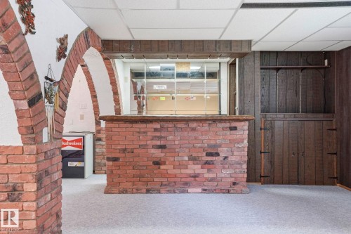 Brick archways and a built-in bar with a brick base - 7 Graham Avenue, St. Albert, AB - Indoor Photo Showing Other Room