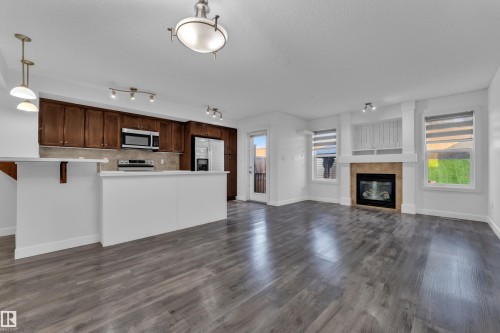 73 Hartwick Loop, Spruce Grove, AB - Indoor Photo Showing Kitchen With Fireplace