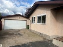 Detached garage with a paneled door, stucco exterior, and sloped roofline - 13831 23 Street Nw, Edmonton, AB  - Outdoor With Exterior 