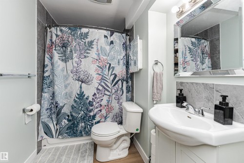 Built-in vanity with integrated sink, chrome faucet, and mirrored medicine cabinet - 4521 29 Avenue Nw, Edmonton, AB - Indoor Photo Showing Bathroom