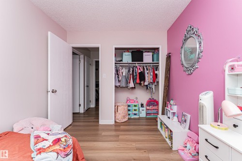 Wood-finish flooring throughout, open closet space, and a bright interior with natural light from the open doorway - 4521 29 Avenue Nw, Edmonton, AB - Indoor Photo Showing Bedroom