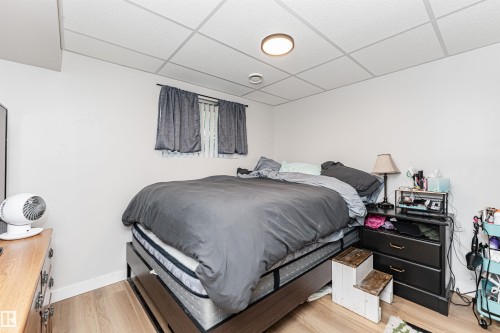 Wood-finish flooring with white walls and a drop ceiling - 4521 29 Avenue Nw, Edmonton, AB - Indoor Photo Showing Bedroom