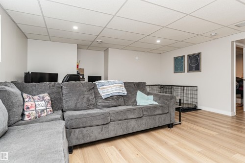 Recessed ceiling lighting, drop ceiling, light wood-finish flooring, white walls, white trim - 4521 29 Avenue Nw, Edmonton, AB - Indoor Photo Showing Living Room