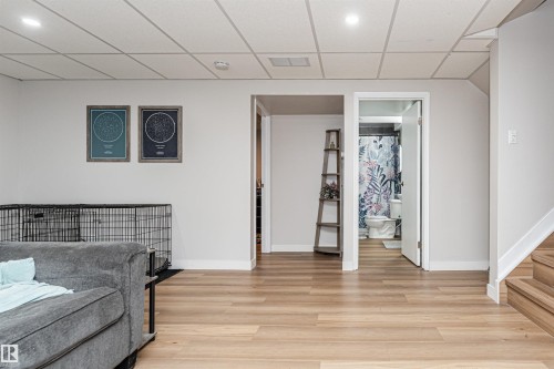 Recessed lighting illuminates the wood-finish flooring and white walls - 4521 29 Avenue Nw, Edmonton, AB - Indoor Photo Showing Other Room
